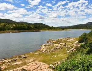Scenic view of a lake with rolling hills