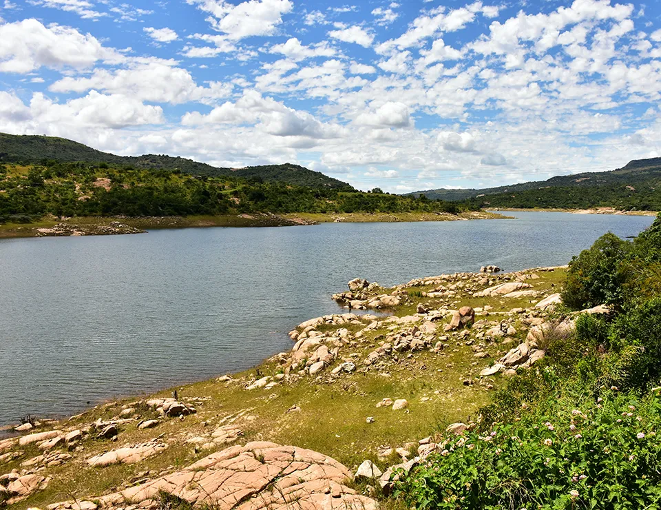 Scenic view of a lake with rolling hills