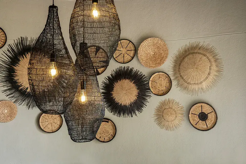 Decorative woven baskets and hanging lamps on wall.