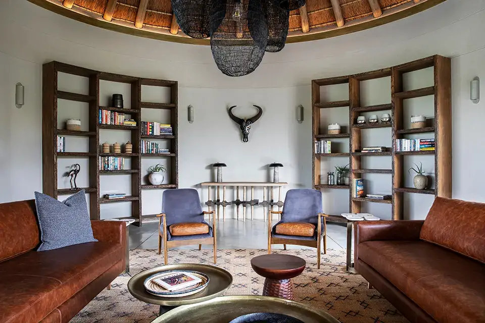 Stylish living room with leather sofas and bookshelves.